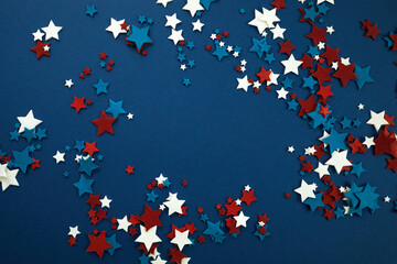 4th of July American Independence Day stars decorations frame on blue background. Flat lay, top view.