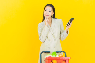 Portrait beautiful young asian woman smile with grocery basket