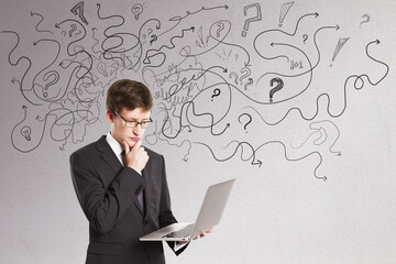 Thoughtful businessman with abstract arrows sketch on concrete wall background. Confusion and direction concept.