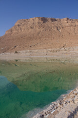 Totes Meer in Israel mit Salzsteinen klarem Waser Spiegelungen und einem Steg