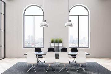 Stylish monochrome conference room in modern office with arched windows and black glossy table...