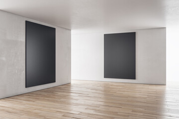 Modern concrete interior with sunlight and empty black frame mockup place. Exhibition, art and advertisement concept. 3D Rendering.