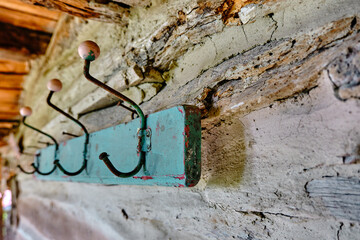 Vintage and retro style clothes hanger or hook in hanging on wooden wall in antique village house in bursa painted as turquoise and blue colour wooden boy