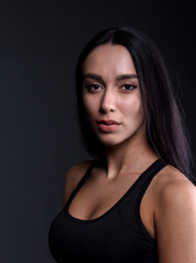 portrait of a young woman in the studio on a dark background