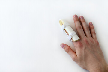 medical splint on a broken finger, on a white background. Medical assistance in case of injury. Copy space