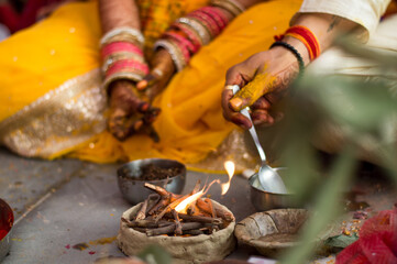 Bride and groom performing a ritual during their wedding in India