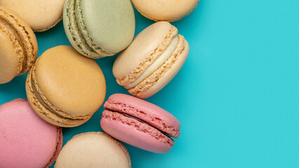 Background from multicolored macaroons on bright blue background top view copy space Backgrounds and textures