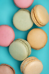 Macaroons, different colors on  dark blue background. Top view, close-up.