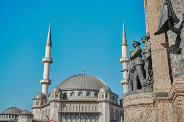 Fototapeta na wymiar Turkey istanbul 03.03.2021. Taksim mosque established in taksim square behind the ataturk monument of taksim republic monument (cumhuriyet ant) at the end of istiklal avenue.