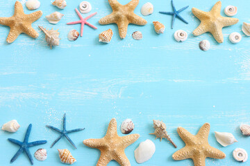 vacation and summer concept with seashells over blue wooden background. Top view flat lay