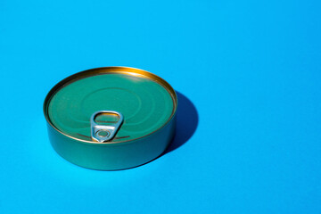 Tin can with food on blue background
