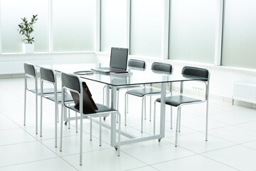 Laptop medical stethoscope coffee cup phone day planner on glass table in office space