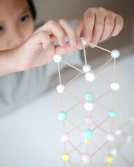 STEM education, Child learning making 3D geometric shapes, Building Structure.