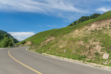 Highways with mountains and grasslands in Xinjiang, China in summer