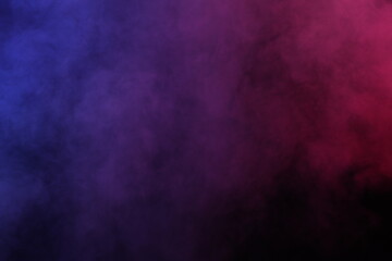 Artificial magic smoke in red-blue light on black background
