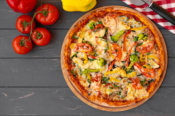 Delicious pizza on gray wooden background top view