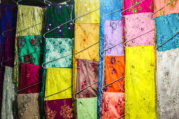 Close up of colorful fabrics dispalyed for sale at Pasar Petisah Traditional Market in Medan, Indonesia