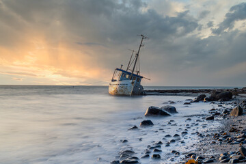 Stranded fishing boat at sunrise