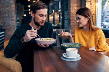 young couple sitting at the table eating healthy lifestyle communication