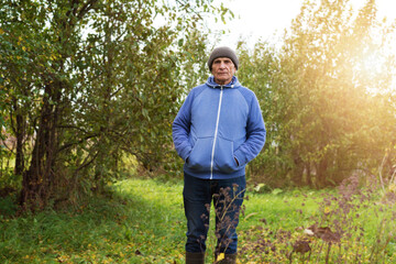 Full length portrait of rustic man wearing warm knitted cap.