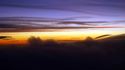 Colorful sunset seen from an airplane window.
Cloud silhouette photo taken kilometers high.