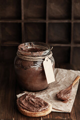 Sweet chocolate-nut dessert in a jar for positive breakfast