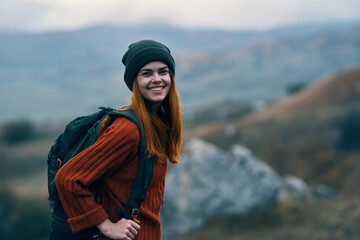 Cheerful female tourist backpack nature mountains landscape travel