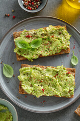 Tasty fresh toast with mashed avocado