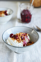 Cherry sauce, cream cheese and feta cream and crumble crust dessert. Homemade Sweet and salty cheesecake. Trifle. Selective focus