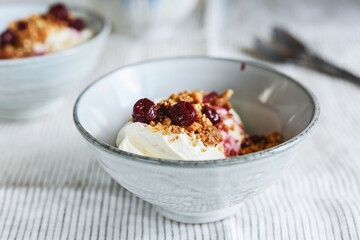 Cherry sauce, cream cheese and feta cream and crumble crust dessert. Homemade Sweet and salty cheesecake. Trifle. Selective focus