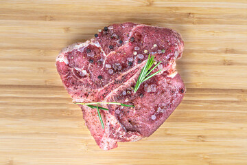 Black angus t bone steak isolated raw meat tbone. Veal beefsteak cut for barbeque. Uncooked aged...