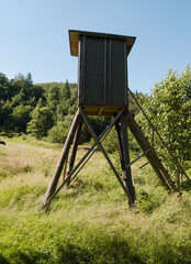 Wooden observation and hunting tower booth in a forest.