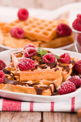 Waffles with raspberries and chocolate cream.