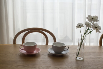Pink empty coffee cup on wooden table.