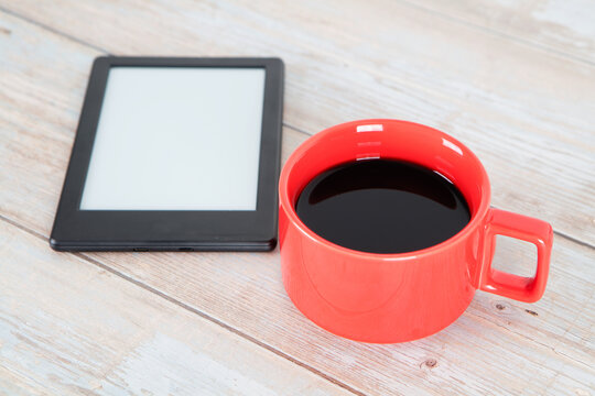 A cup of coffee and e-book reader