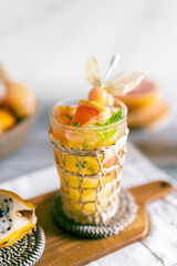 Bright food photography of a tropical cocktail with natural juice. Backdrop with a basket with...