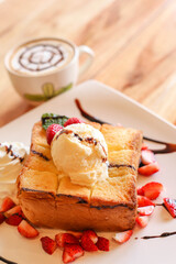 Honey toase with icecream on wood table.