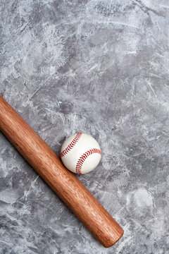 Baseball ball and bat on grey background. Team sport concept