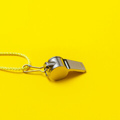 Sports whistle on yellow background. Concept- sport competition, referee, statistics, challenge....