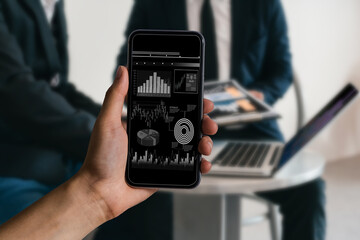 Investor analyzing stock market investments with financial dashboard and key performance indicators on smartphone and computer screens.