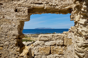 Levanzo Island of the Egadi archipelago in Sicilia seen from the ancient stones of the Tonnara di Trapani in ruins