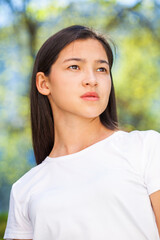 Portrait of a young beautiful girl in summer park