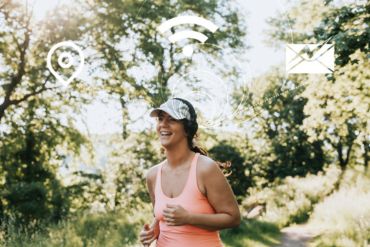Woman jogging with headphones connected to various internet services