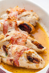 chicken rolls stuffed with dry tomatoes in bacon