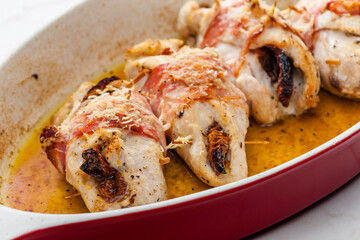 chicken rolls stuffed with dry tomatoes in bacon