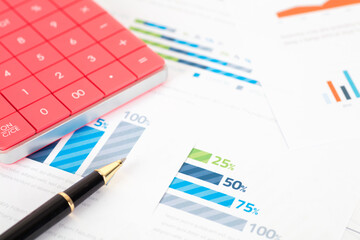 Calculator and pen on business chart