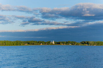 White clouds in the blue sky over the river. Summer bright day on vacation.