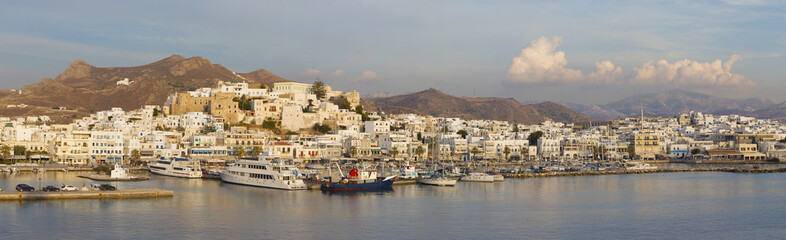 Fototapeta na wymiar CHORA, GREECE - OCTOBER 7, 2015: The panorama of town Chora (Hora) on the Naxos island at evening light in the Aegean Sea.