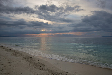 Fototapeta na wymiar tropical dusk over the sea with cloudy sky