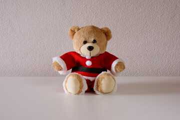 Teddy bear wearing christmas costume on white background